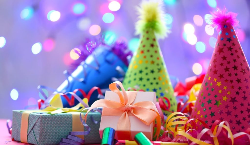 Colorful birthday party hats, gift boxes, and streamers for a kids backyard party on Long Island